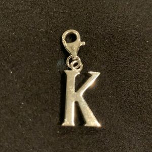 Silver “K” charm.